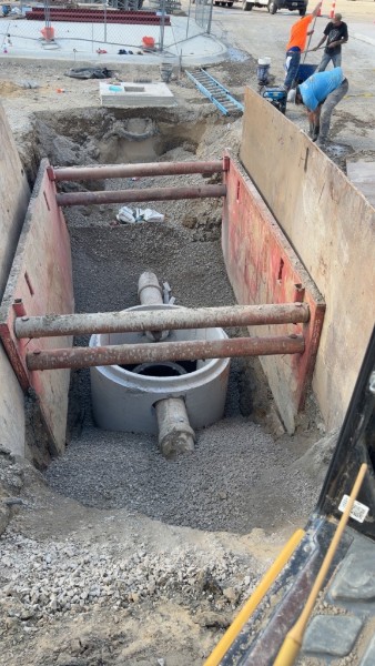 Worker inside a shored utility trench
