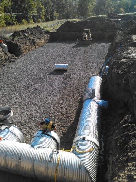 Underground pipe junctions set on a stone base