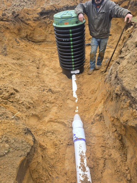 Vertical drainage structure connected below grade