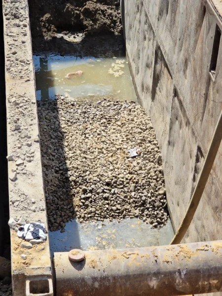 Stone base prepared beside a shored excavation